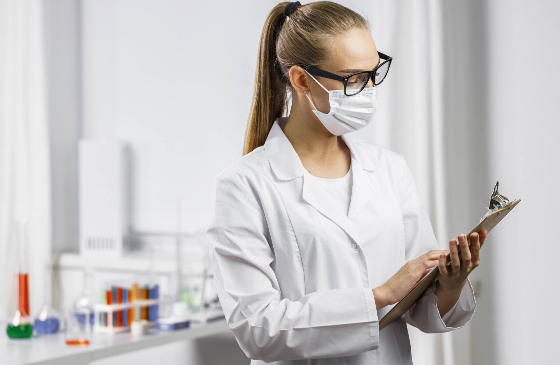 portrait-female-researcher-with-medical-mask-clipboard